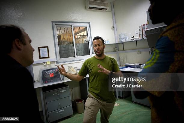 Nathan Wolfe, center, founder, and principal investigator, of the Global Viral Forecasting Initiative talks with his team at the Wolfelab on...