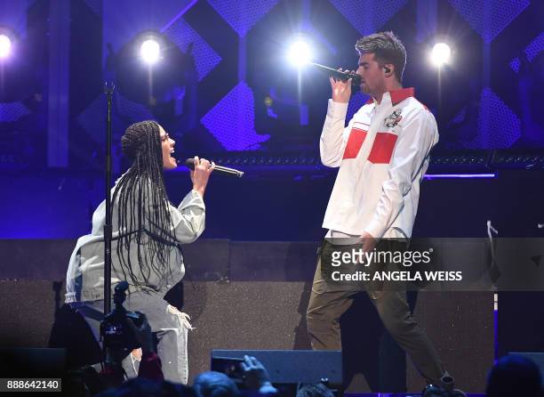 The Chainsmokers with Halsey perform at the Z100's iHeartRadio Jingle Ball 2017 at Madison Square Garden on December 7, 2017 in New York. / AFP PHOTO...