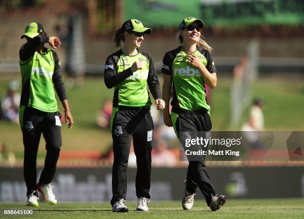 Rachel Haynes and Nicola Carey of the Thunder celebrate victory as they leave the field after the Women's Big Bash League WBBL match between the...