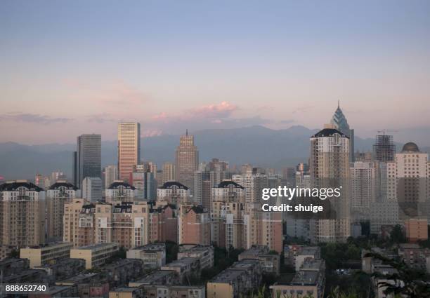 urumqi cityscape at sunset - urban skyline xinjiang stock pictures, royalty-free photos & images