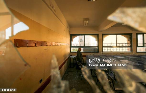 Palestinian teacher inspects the damage at a school on December 9 in the aftermath of an Israeli air strike in Beit Lahia, in the northern Gaza...