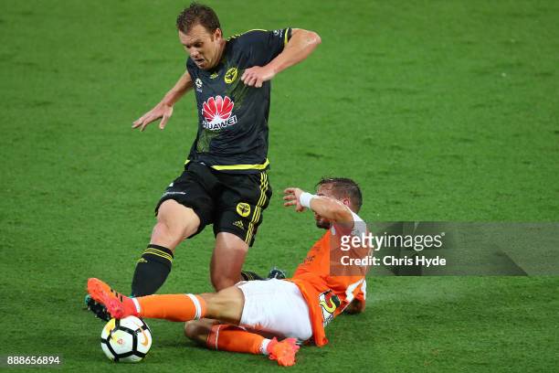 Daniel Mullen of the Phoenix and Eric Bautheac of the Roar compete for the ball during the round 10 A-League match between the Brisbane Roar and the...