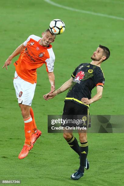 Dario Vidosic of the Phoenix and Daniel Bowles of the Roar compete for the ball during the round 10 A-League match between the Brisbane Roar and the...