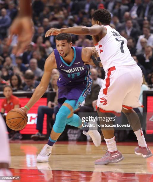Michael Carter-Williams of the Charlotte Hornets dribbles as he is guarded by Kyle Lowry of the Toronto Raptors during NBA game action at Air Canada...