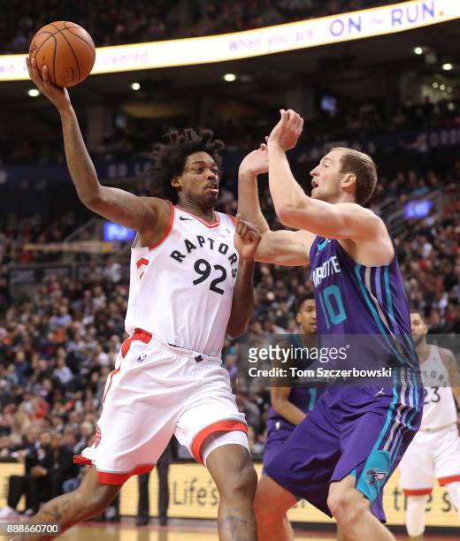 Lucas Nogueira of the Toronto Raptors drives to the basket against Cody Zeller of the Charlotte Hornets during NBA game action at Air Canada Centre...