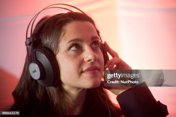 Candidate of the Ciutadans party Ines Arrimadas puts on headphones during a visit to a Ciudadanos election campaign stand on 8 December 2017 in...