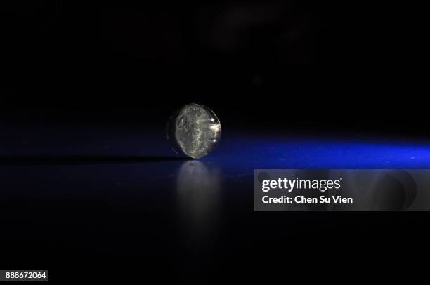 coin spinning on table - spinning coin stock pictures, royalty-free photos & images