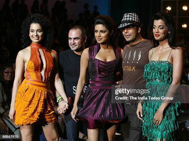 Priyanka Chopra along with Mugdha Godse, Kangna Ranaut, Fashion Designer Narendra Kumar and hair stylist Andrew Barton are walking on the ramp with...