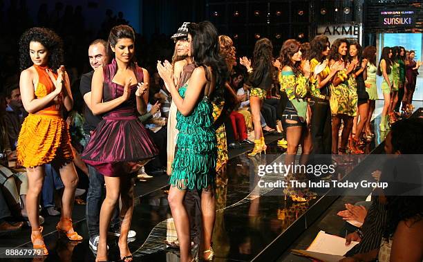 Priyanka Chopra along with Mugdha Godse, Kangna Ranaut, Fashion Designer Narendra Kumar and hair stylist Andrew Barton are walking on the ramp with...