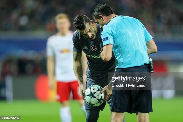 Alvaro Negredo of Besiktas speak with Referee Viktor Kassai during the UEFA Champions League group G soccer match between RB Leipzig and Besiktas at...