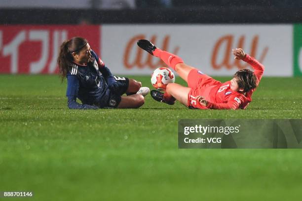 Rumi Utsugi of Japan and Lee Sodam of South Korea compete for the ball during the EAFF E-1 Women's Football Championship between Japan and South...