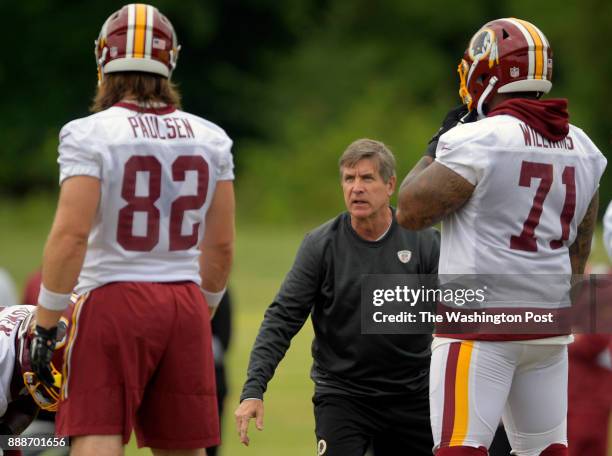 Washington offensive line coach Bill Callahan, center, instructs TE Logan Paulsen, left, and Trent Williams during the 2nd day of the Washington...