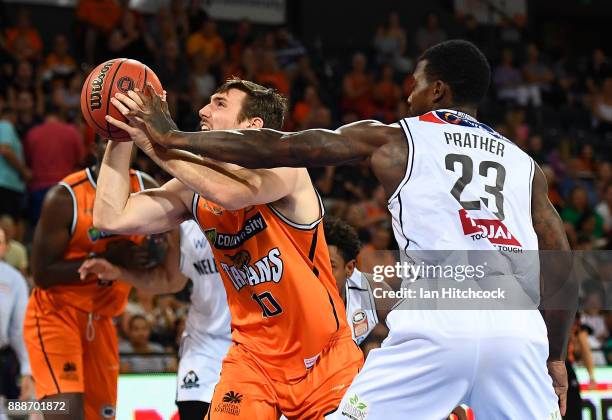 Mitch McCarron of the Taipans is fouled by Casey Prather of Melbourne United during the round nine NBL match between the Cairns Taipans and Melbourne...