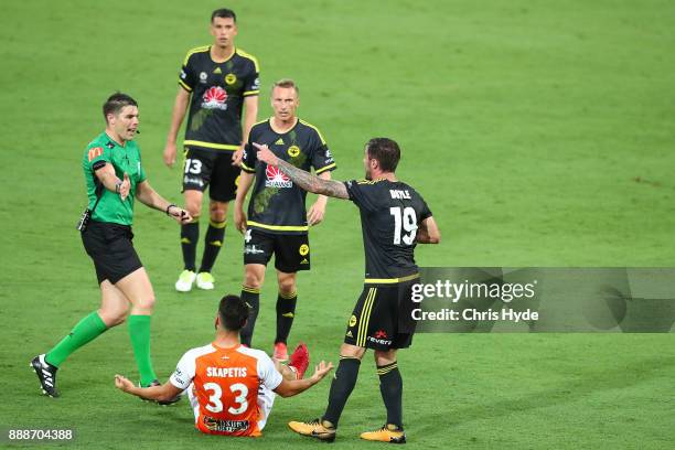 Tom Doyle of the Phoenix is handed a yellow card during the round 10 A-League match between the Brisbane Roar and the Wellington Phoenix at Cbus...