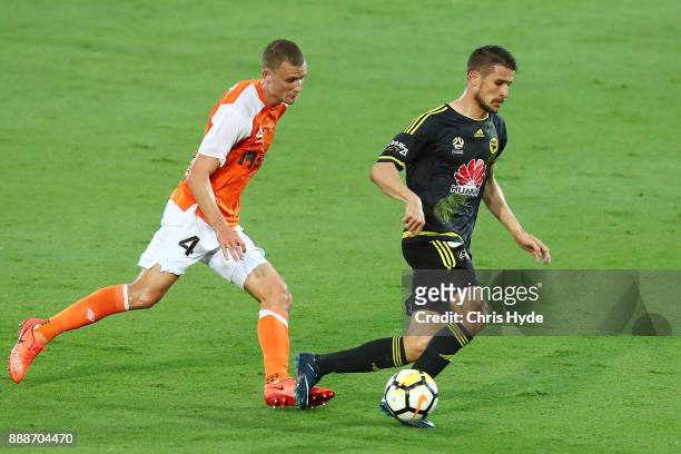 Dario Vidosic of the Phoenix and Daniel Bowles of the Roar compete for the ball during the round 10 A-League match between the Brisbane Roar and the...