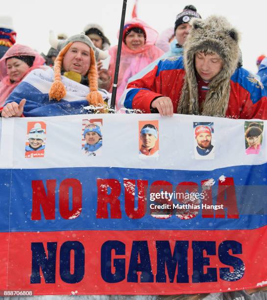 Biathlon fans from Russia demonstrate with a banner against the IOC bann for Russia from the Winter Olympics prior to the 12.5 km Men's Pursuit...