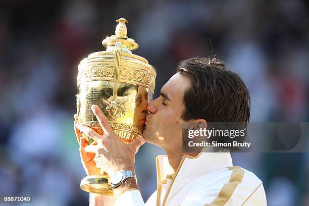 Switzerland Roger Federer victorious, kissing Gentlemen's Singles Trophy after winning Finals match vs USA Andy Roddick at All England Club. London,...