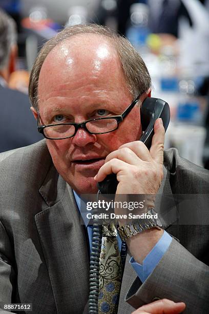 General Manager Bob Murray of the Anaheim Ducks looks on from the Ducks draft table during the second day of the 2009 NHL Entry Draft at the Bell...