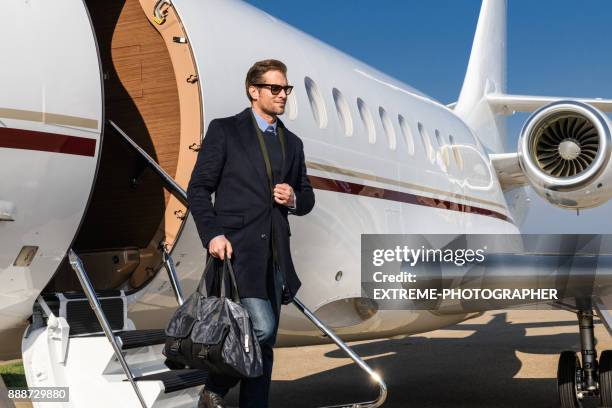 man at the airport - private aeroplane stock pictures, royalty-free photos & images