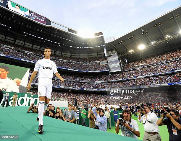 Real Madrid's new player Portuguese Cristiano Ronaldo gestures during his official presentation at the Santiago Bernabeu stadium in Madrid on July 6,...