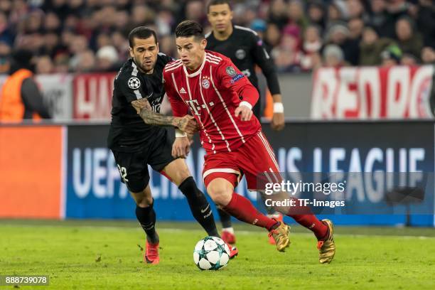 Dani Alves of Paris Saint-Germain and James Rodriguez of Bayern Muenchen battle for the ball during the UEFA Champions League group B match between...