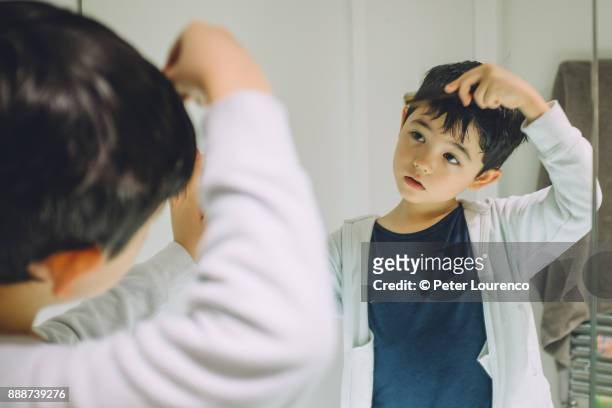 young boy getting ready to go out. - peter lourenco stock-fotos und bilder