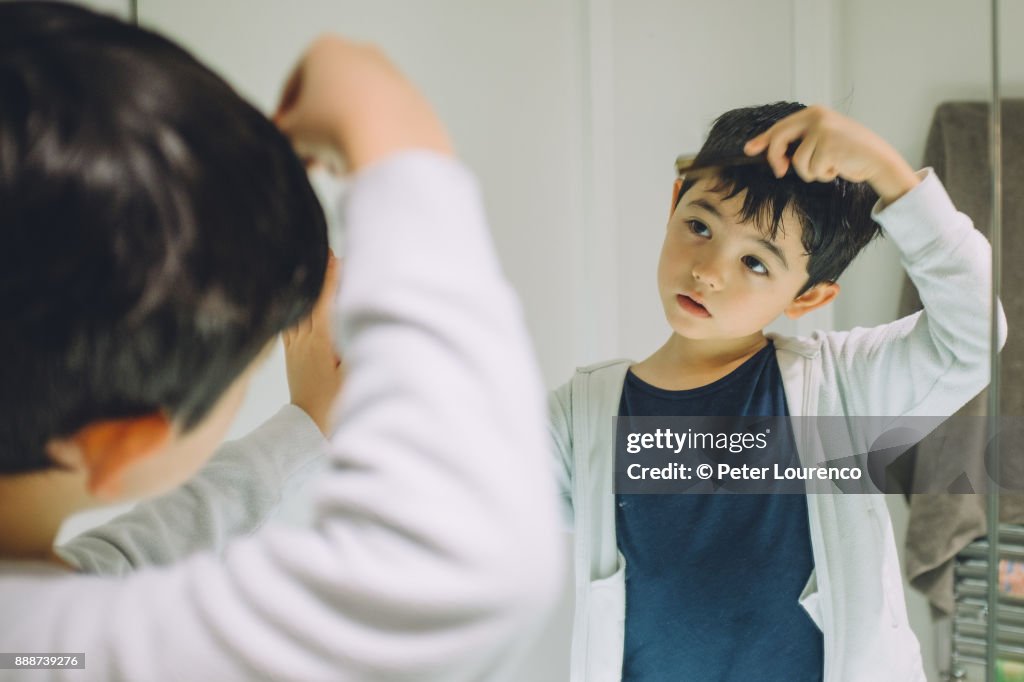 Young boy getting ready to go out.