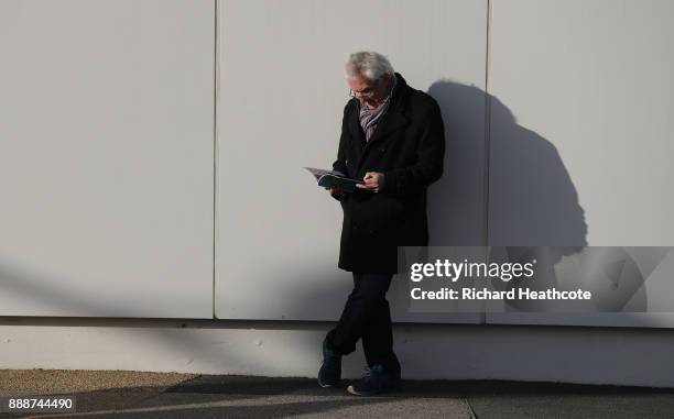 Fan reads the matchday programme prior to the Premier League match between West Ham United and Chelsea at London Stadium on December 9, 2017 in...