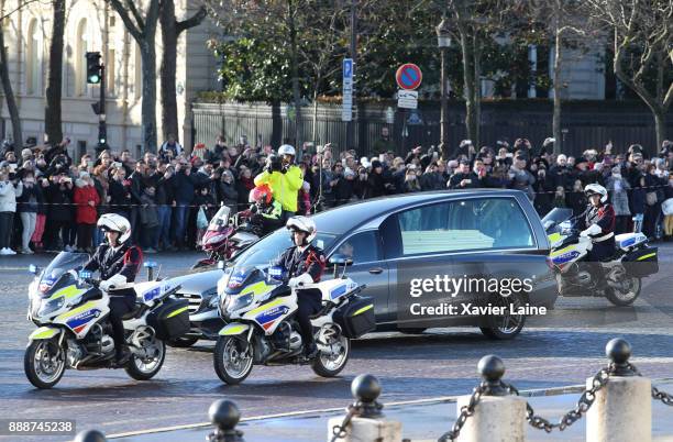 Johnny Hallyday's Funeral Procession with hundreds of bikers flanking his coffin down the Champs Elysees on December 9, 2017 In Paris. France pays...