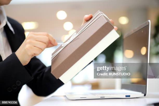 cropped image of businesswoman holding gift box - brown box stock pictures, royalty-free photos & images