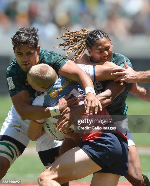 Vladimir Ostroushko of Russia tackled by Chris Dry of South Africa and Justin Geduld of South Africa during day 1 of the 2017 HSBC Cape Town Sevens...