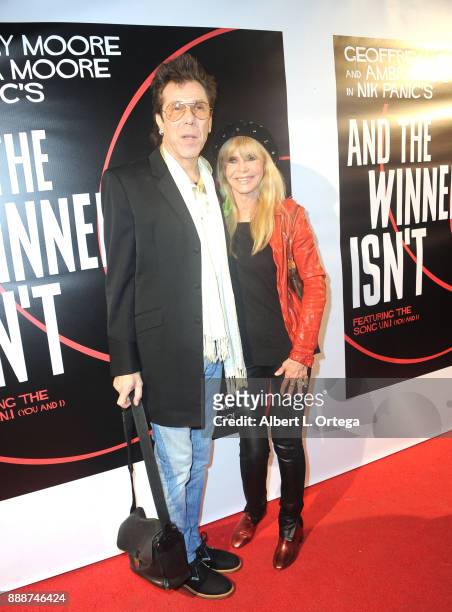 Musician/ex-husband Slim Jim Phantom and actress Britt Ekland arrive for the Premiere Of "And The Winner Isn't" at Laemmle Music Hall on December 8,...