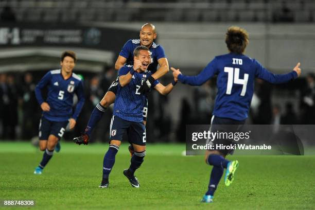 Yosuke Ideguchi of Japan celebrates scoring the opening goal with his team mates during the EAFF E-1 Men's Football Championship between Japan and...