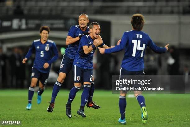 Yosuke Ideguchi of Japan celebrates scoring the opening goal with his team mates during the EAFF E-1 Men's Football Championship between Japan and...