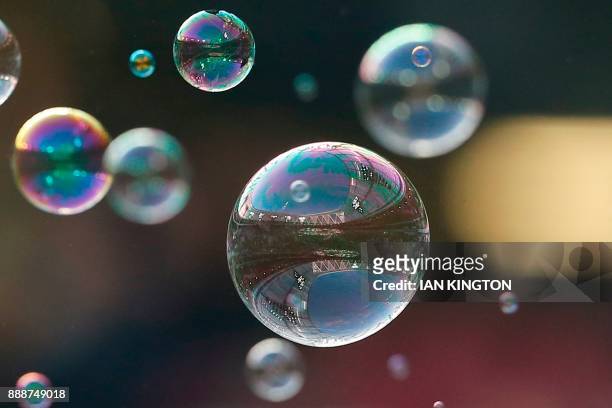 The stadium is reflected in bubbles seen ahead of the English Premier League football match between West Ham United and Chelsea at The London...