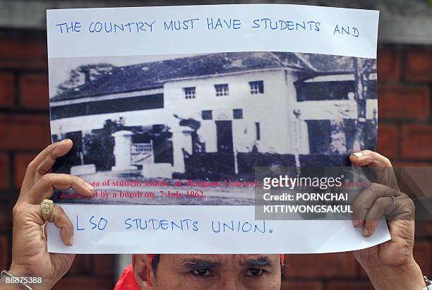 Myanmar activist holds a picture of Yangon university during a demonstration at the Myanmar embassy in Bangkok on July 7, 2009. The activists were...