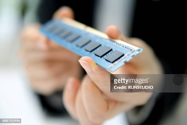 businesswoman holding memory chip - ram stock pictures, royalty-free photos & images
