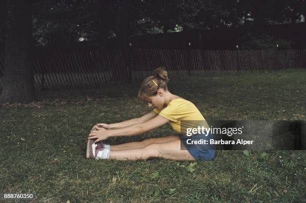 Woman stretching after a workout in Riverside Park, New York City, US, September 1985.