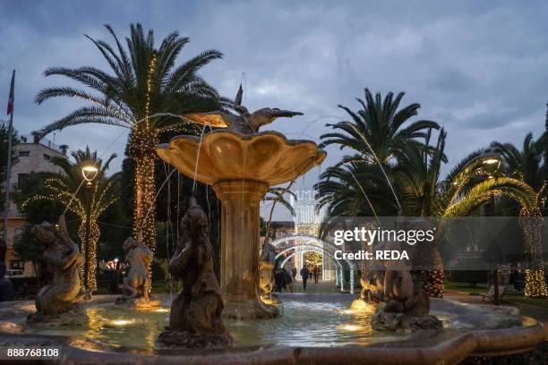 Fountain. Public Gardens. Christmas illuminations. People. Civitanova Marche. Marche. Italy. Europe.