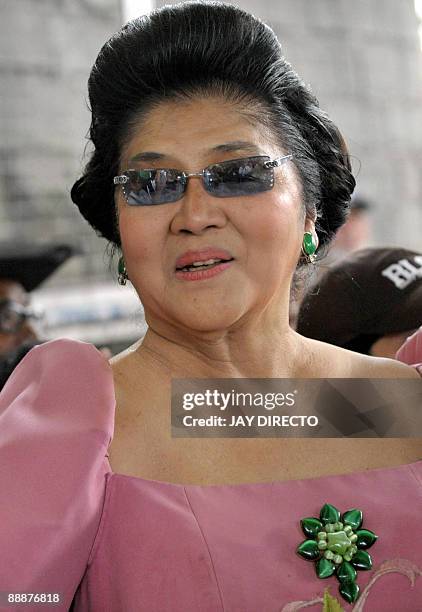 Former first lady Imelda Marcos speaks as she arrives in suburban Payatas district north of Manila to distribute rice to hundreds of poor families on...