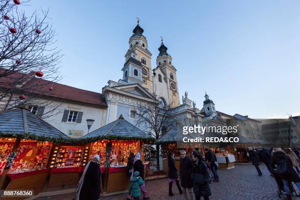 The Christmas Market in Brixen on the medieval market place Europe. The steeples of Brixen cathedral in the background. Europe. Central Europe....
