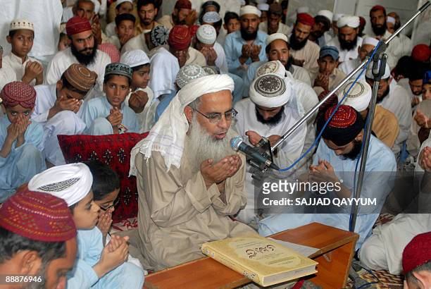Chief cleric of the Red Mosque, Maulana Abdul Aziz , flanked by followers, prays for those who were killed in the July 2007 military operation in...
