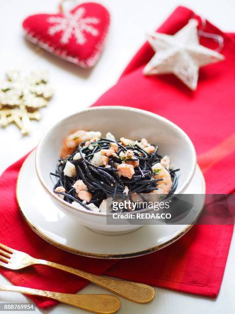 Spaghetti pasta with squid ink. Christmas dinner. Italy. Europe.