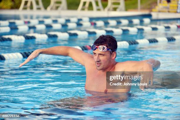 Ryan Lochte working on stroke definition with teens and babies who learned to swim through Baby Otter at Central Park Aquatic Complex on December 03,...