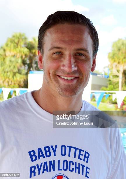 Ryan Lochte working on stroke definition with teens and babies who learned to swim through Baby Otter at Central Park Aquatic Complex on December 03,...