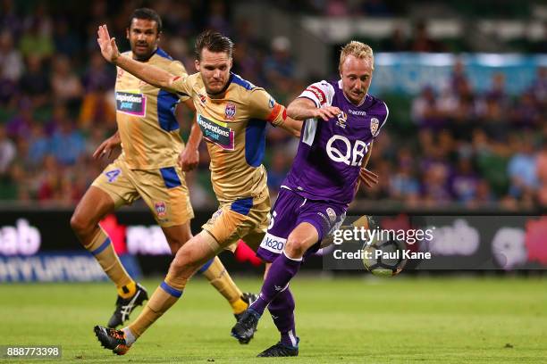 Mitch Nichols of the Glory controls the ball against Nigel Boogaard of the Jets during the round 10 A-League match between the Perth Glory and the...