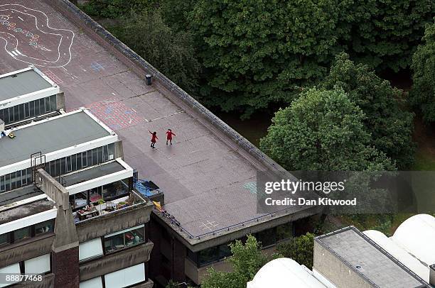 Children play on the roof of a building as seen from Cromwell Tower on the Barbican Estate on July 7, 2009 in London, England. Many of London's...