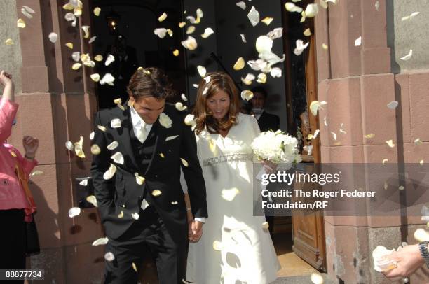 Roger Federer and Mirka Vavrinec are showered with confetti after their wedding on April 11, 2009 in Basel, Switzerland.