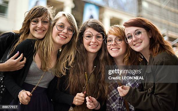 Fans wearing home-made "Harry Potter"-style glasses wait in Leicester Square in central London, ahead of the world premiere of the latest in the...