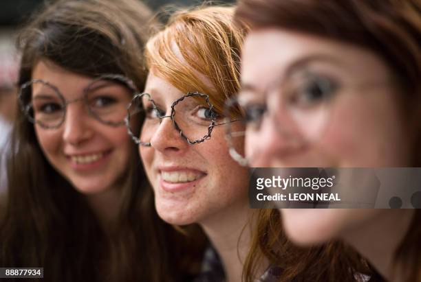 Fans wearing home-made "Harry Potter"-style glasses wait in Leicester Square in central London, ahead of the world premiere of the latest in the...